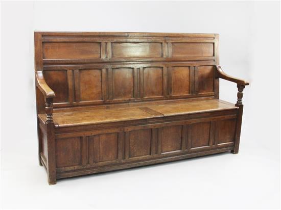 A panelled oak box seat settle, W.6ft 1in.